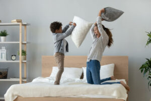 Mum and child have a pillow fight