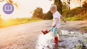child playing in puddles