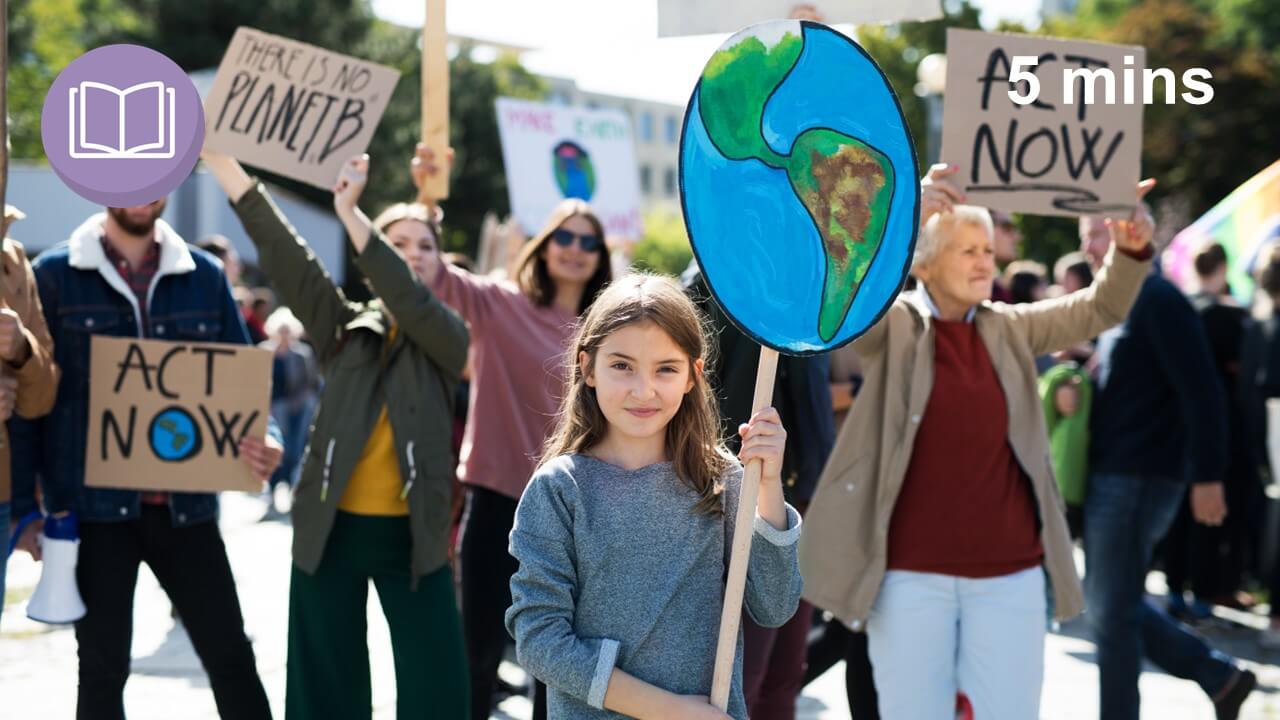 girl holding a placard at a climate crisis rally