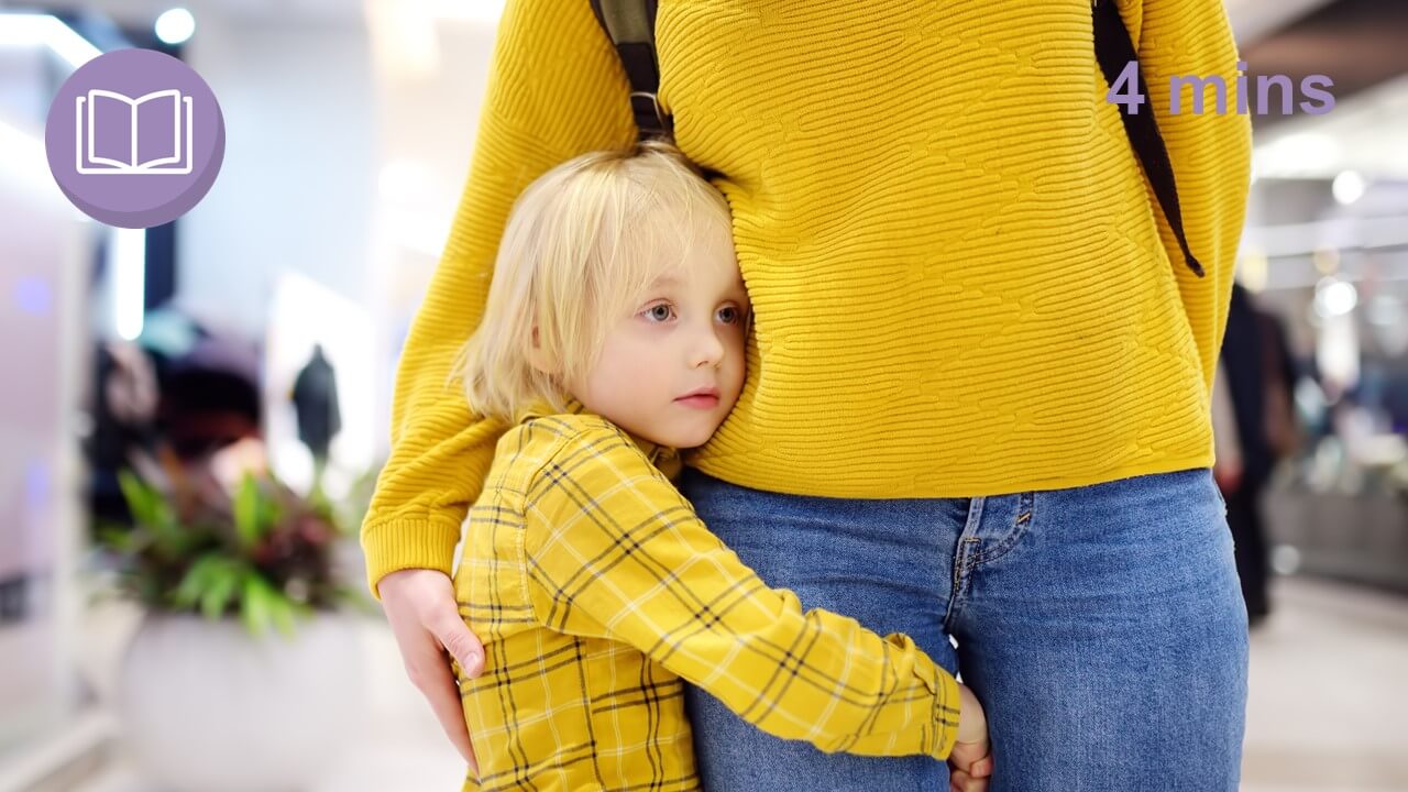 child clings to parents leg anxious about leaving them