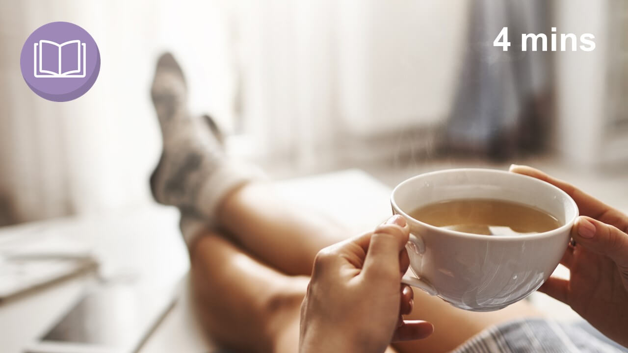 self care woman having a cup of tea with her feet up